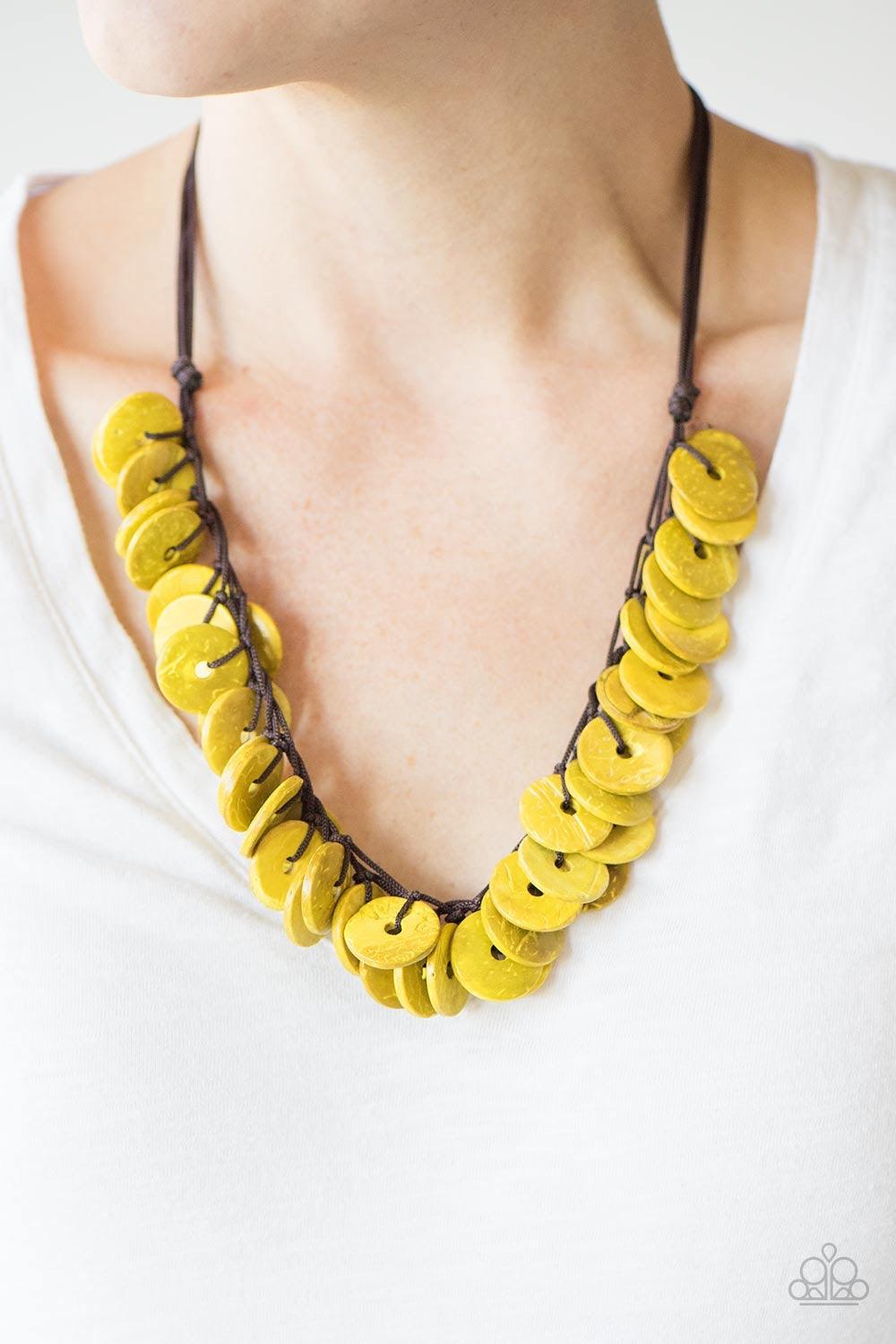 Paparazzi Accessories Jammin In Jamaica - Yellow Shiny wooden discs brushed in a yellow finish trickle along shiny black cording, creating clustered layers below the collar. Features a button-loop closure. Jewelry