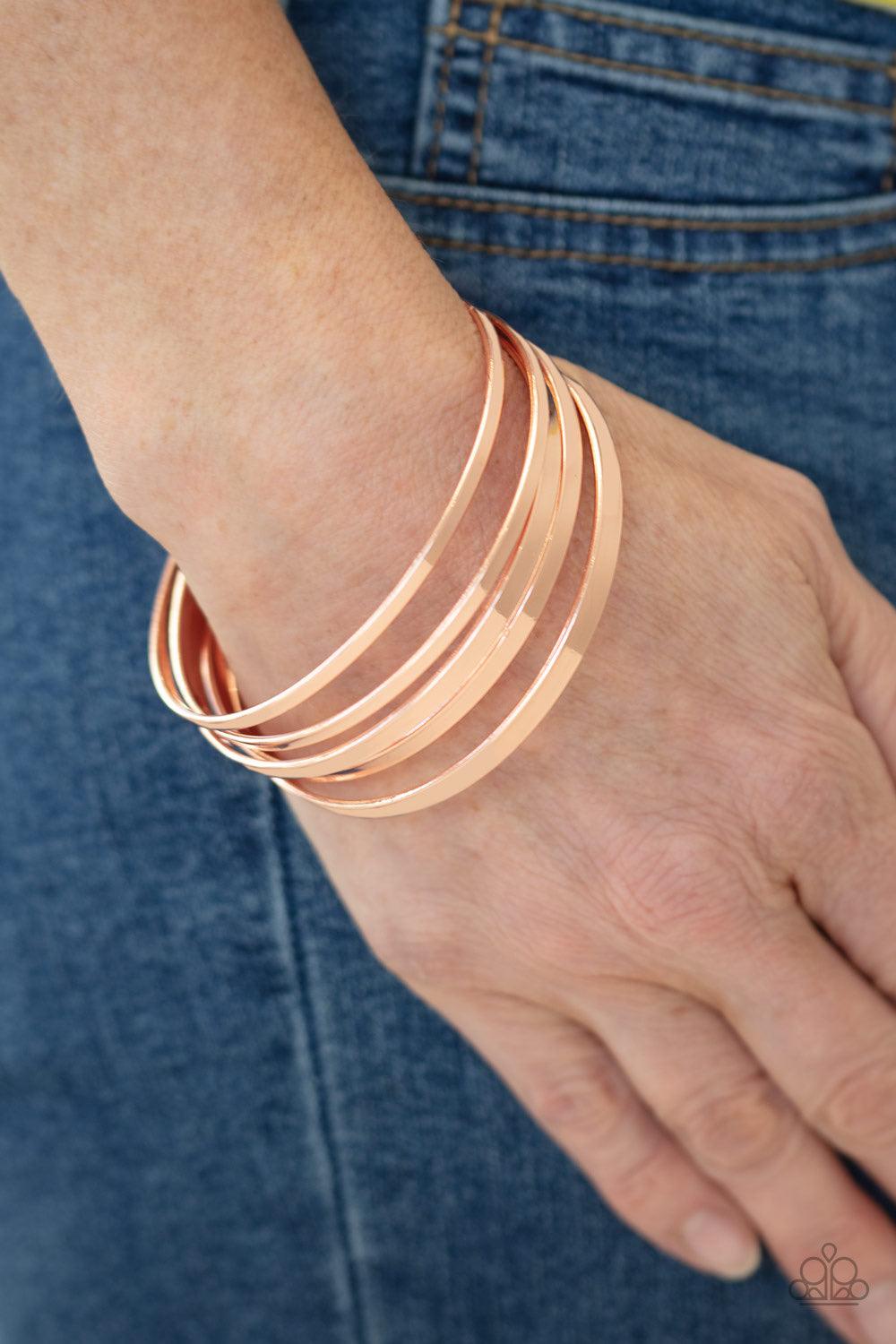 Paparazzi Accessories Ensnared - Copper A collection of flat shiny copper bangles stack along the wrist, creating an irresistible edgy shimmer. Jewelry
