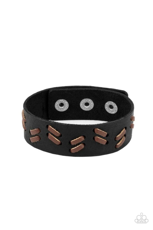 Paparazzi Accessories Suburban Wrangler - Black Brown leather laces are decoratively threaded through a black leather band, creating a rustic pattern around the wrist. Features an adjustable snap closure. Jewelry