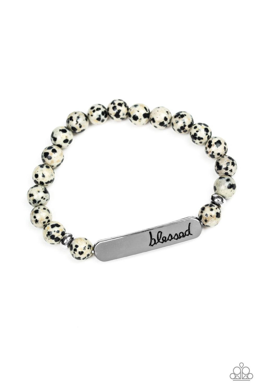 Paparazzi Accessories Simply Blessed - Black A collection of speckled stones, dainty silver beads, and a silver plate stamped with the inspirational word, "blessed", are threaded along a stretchy band around the wrist for a seasonal look. Jewelry