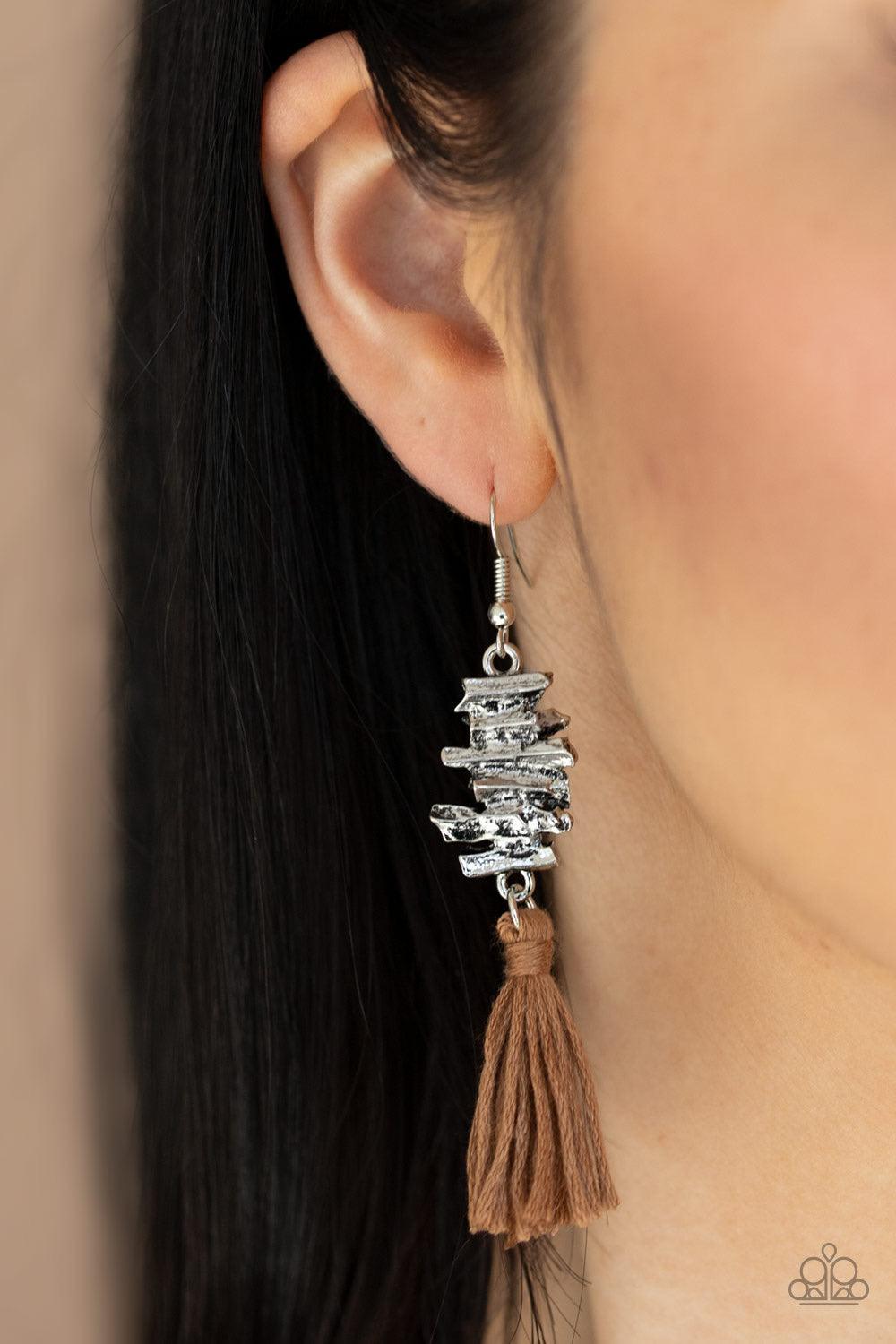 Paparazzi Accessories Tiki Tassel - Brown An earthy brown threaded tassel swings from the bottom of an abstractly stacked silver frame, creating a colorful fringe. Earring attaches to a standard fishhook fitting. Jewelry