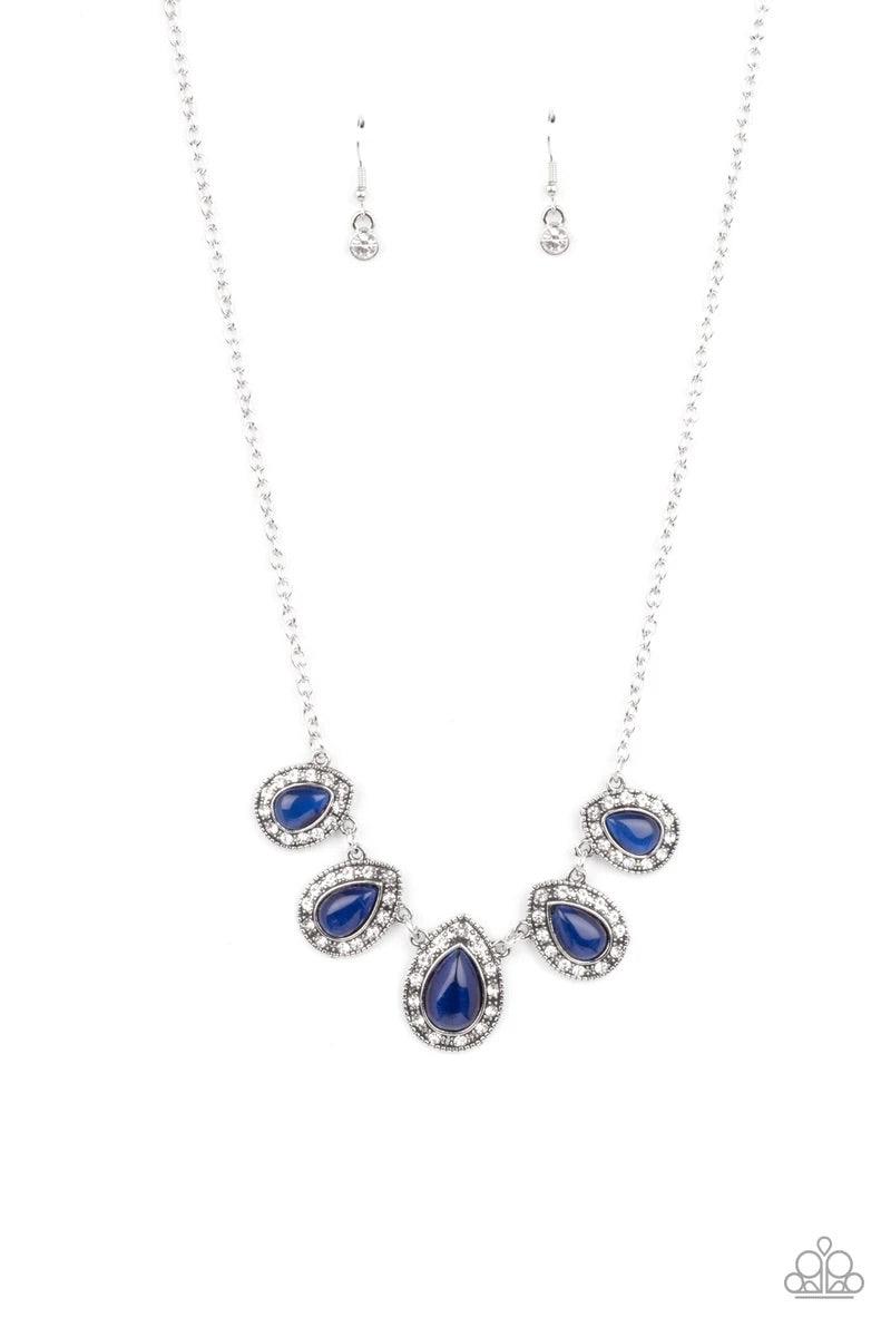 Paparazzi Accessories Everlasting Enchantment - Blue Bordered in glassy white rhinestones, glowing blue cat's eye stone frames delicately increase in size as they link below the collar, creating an enchanting display. Features an adjustable clasp closure.