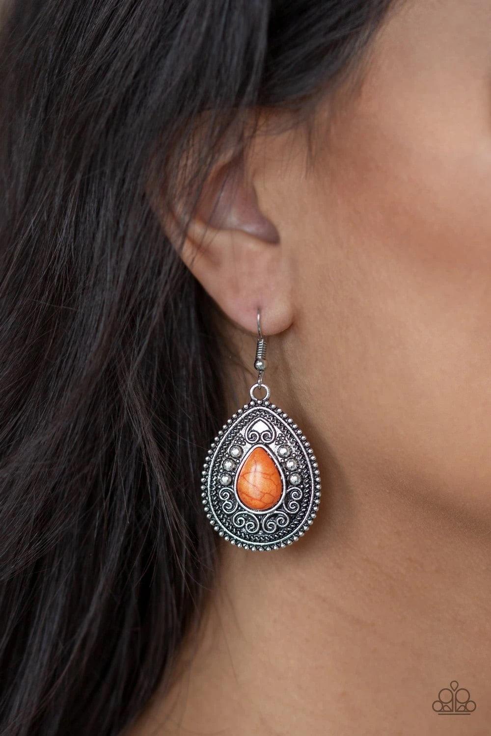 Paparazzi Accessories Desert Nirvana - Orange Chiseled into a tranquil teardrop, a vivacious orange stone is pressed into the center of an ornate silver frame radiating with studded and antiqued filigree patterns for a seasonal look. Earring attaches to a