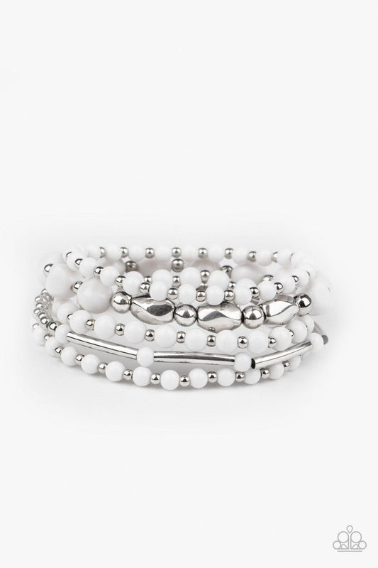 Paparazzi Accessories Vibrantly Vintage ~White Infused with dainty silver beads, a mismatched collection of white and shiny silver beads are threaded along stretchy bands around the wrist for a colorfully layered look. Sold as one set of five bracelets.