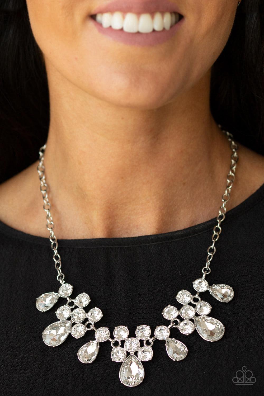 Paparazzi Accessories Debutante Drama - White A collection of round and teardrop white rhinestones coalesce into dazzling frames as they link below the collar, creating a glamorous fringe. Features an adjustable clasp closure. Jewelry