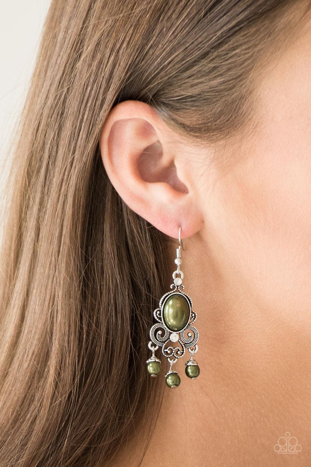 Paparazzi Accessories I Better Get GLOWING ~Green Dotted silver filigree spins around a pearly green bead and dainty white rhinestones, coalescing into a regal frame. A pearly fringe swings from the bottom of the frame for a refined finish. Earring attach