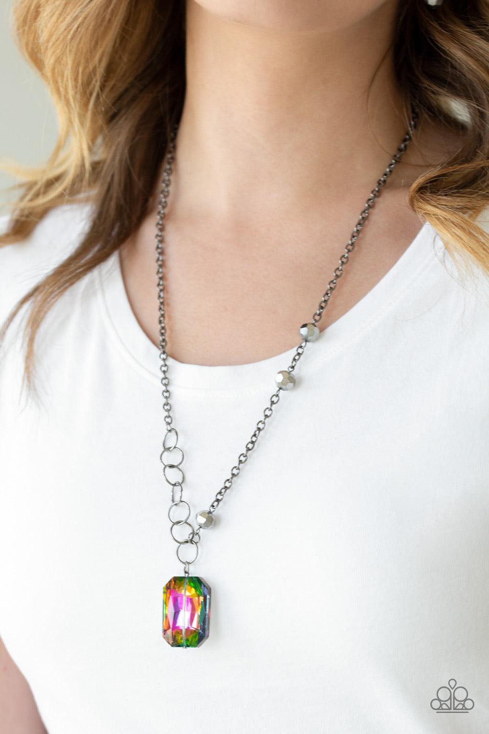 Paparazzi Accessories Never A Dull Moment - Multi A trio of faceted hematite crystal-like beads asymmetrically trickle along a mismatched gunmetal chain. Featuring a regal emerald-cut, an oversized rainbow gem swings from the bottom of the gunmetal chain