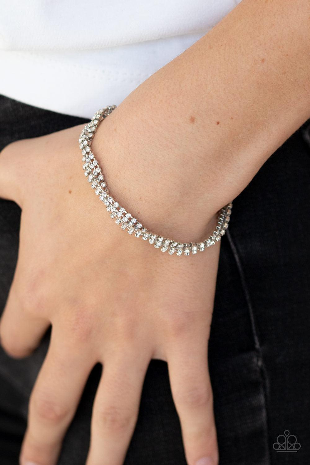 Paparazzi Accessories Braided Twilight - White Infused with glistening silver fittings, strands of glassy white rhinestones delicately braid across the wrist in timeless fashion. Features an adjustable clasp closure. Jewelry