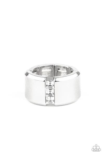 Paparazzi Accessories The Graduate - White A single row of square-cut white rhinestones stack down the center of a thick silver band. Features a stretchy band for a flexible fit. Sold as one individual ring. Rings