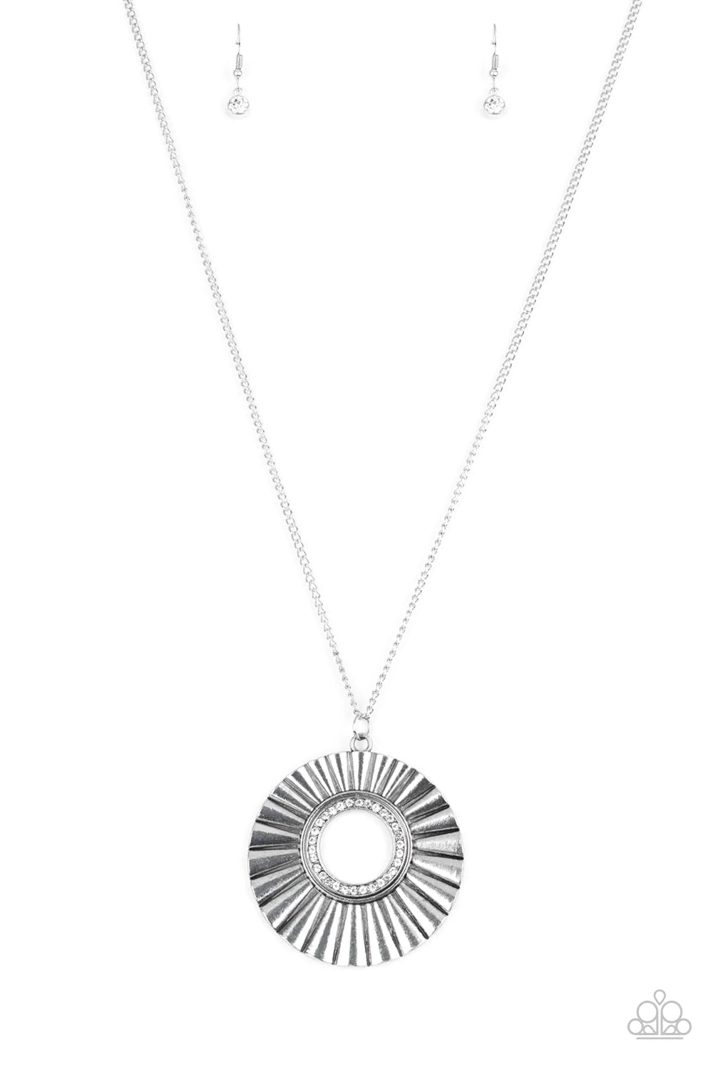 Paparazzi Accessories Chicly Centered - White Brushed in a gritty antiqued finish, a rippling silver frame flares from a white rhinestone encrusted center for an edgy look. Features an adjustable clasp closure. Sold as one individual necklace. Includes on