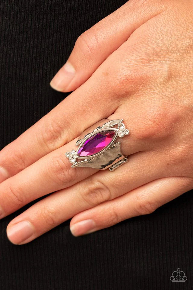 Paparazzi Accessories Planetary Paradise - Pink An oversized marquise cut pink iridescent gem asymmetrically balances between two flared and hammered silver frames. Clusters of dainty white rhinestones flanks the spellbinding centerpiece for a delicate fi