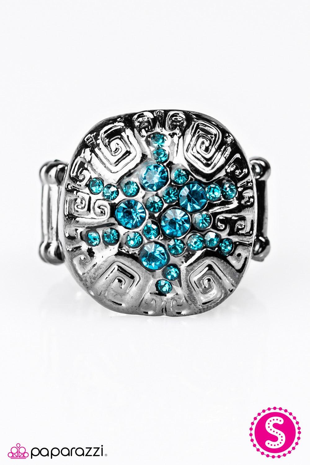 Paparazzi Accessories Have A Blast - Blue A glistening gunmetal frame is etched in indigenous inspired patterns. An explosion of glittery blue rhinestones radiate from the center for a blast of color. Jewelry