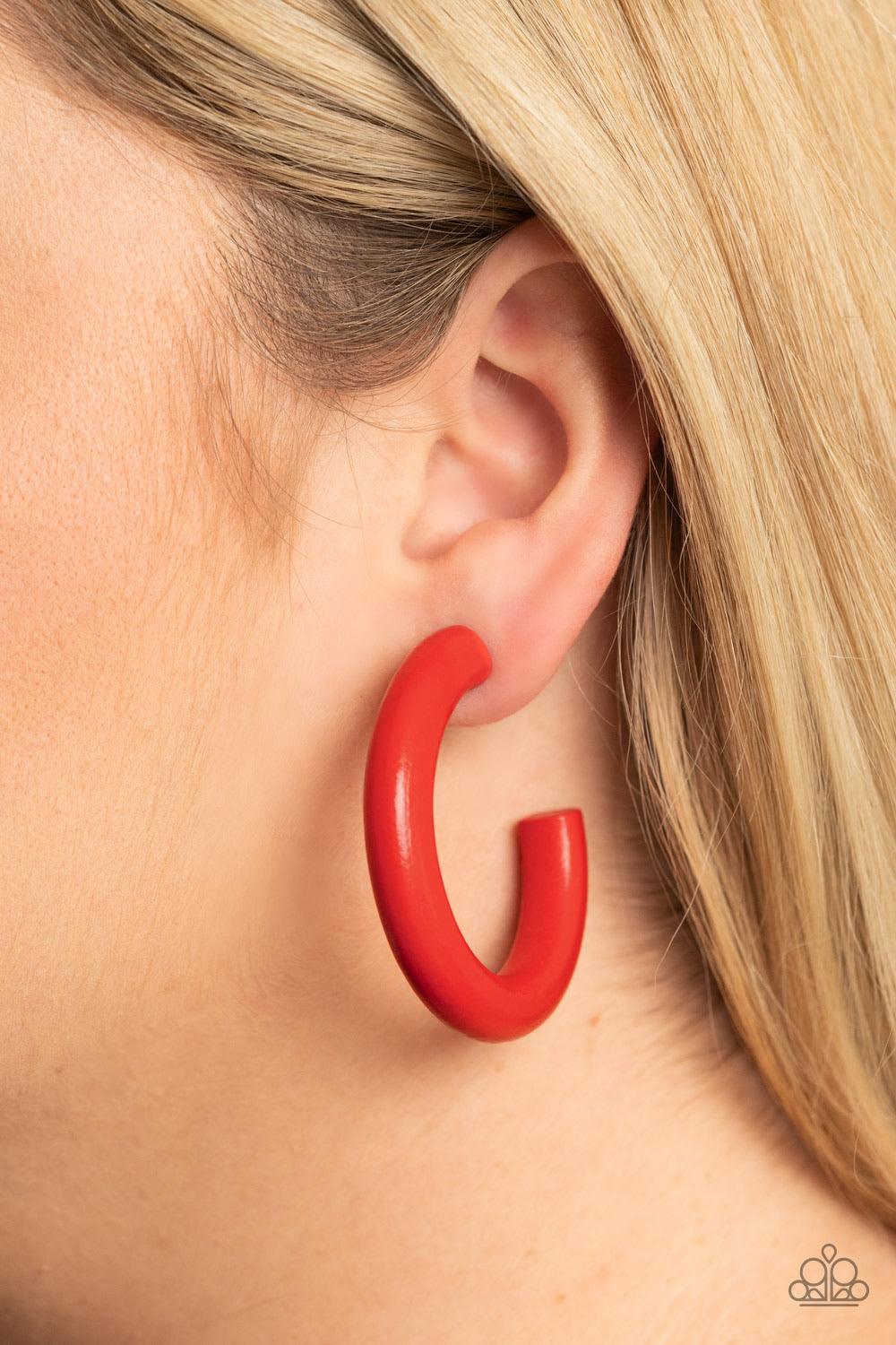 Paparazzi Accessories Woodsy Wonder ~Red Painted in a fiery red finish, a thick wood hoop curls around the ear for a flirtatiously colorful look. Earring attaches to a standard post fitting. Hoop measures approximately 2" in diameter. Sold as one pair of
