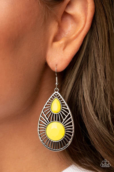 Paparazzi Accessories Prima Donna Diva - Yellow An oversized pair of faceted round and teardrop Illuminating beads embellish the front of a shiny silver teardrop radiating with linear stenciled patterns, resulting in a colorful lure. Earring attaches to a