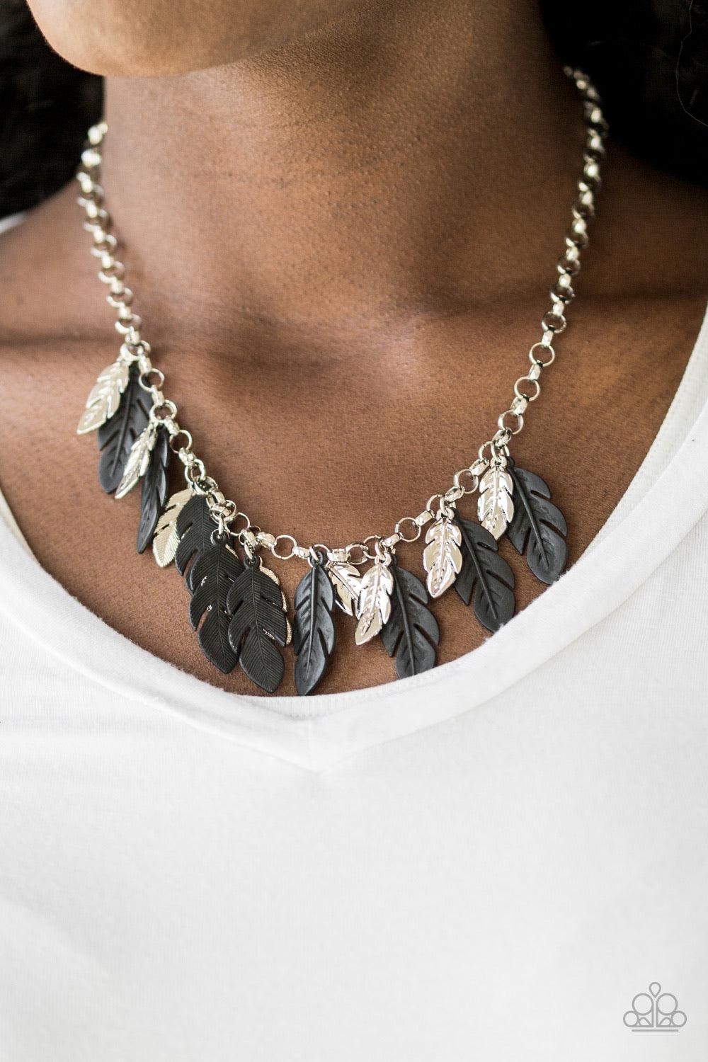 Paparazzi Accessories Rule The Roost - Black Glistening silver and shiny black feathers swing from the bottom of a bold silver chain, creating a fierce fringe below the collar. Features an adjustable clasp closure. Sold as one individual necklace. Include