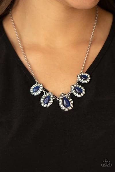 Paparazzi Accessories Everlasting Enchantment - Blue Bordered in glassy white rhinestones, glowing blue cat's eye stone frames delicately increase in size as they link below the collar, creating an enchanting display. Features an adjustable clasp closure.