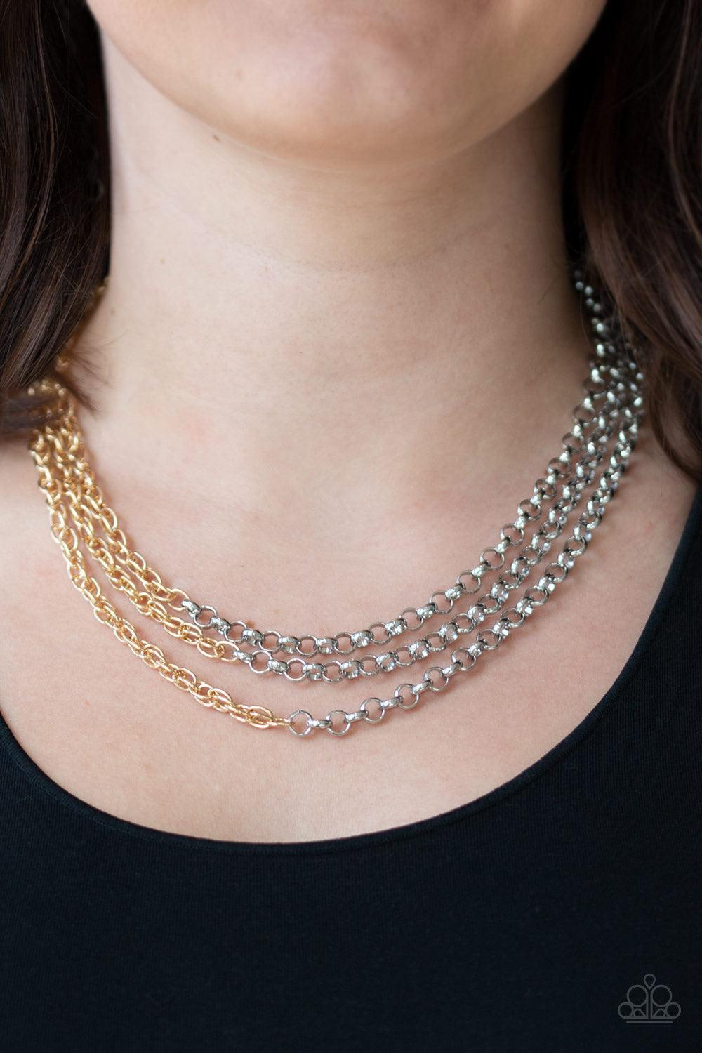 Paparazzi Accessories Metro Madness - Silver Strung between two silver fittings, glistening silver chains collide with shimmery gold chains below the collar, creating edgy mixed metallic layers. Features an adjustable clasp closure. Sold as one individual