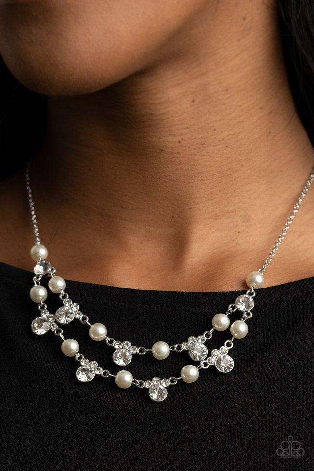 Paparazzi Accessories Royal Announcement - White A bubbly collection of white pearls and glassy white rhinestones delicately connect into two timeless rows below the collar, creating a stunning statement piece. Features an adjustable clasp closure. Jewelr