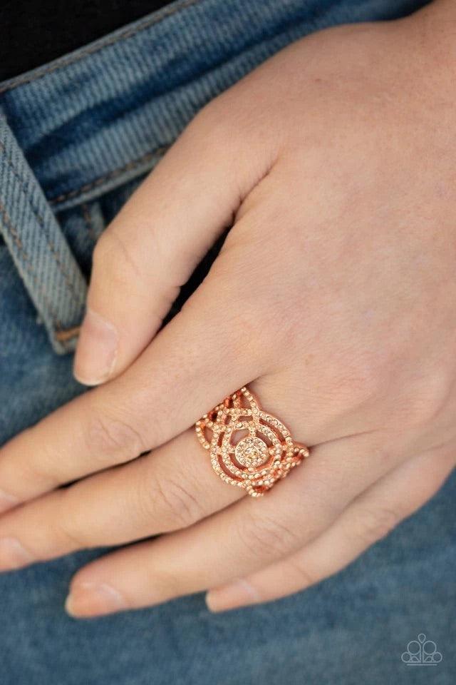 Paparazzi Accessories COUNTESS To-Ten - Copper Dotted in dainty peach rhinestones, dainty shiny copper bands swirl and whirl across the finger, coalescing into a refined frame. Features a stretchy band for a flexible fit. Sold as one individual ring. Jewe