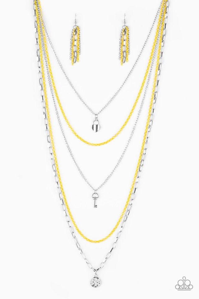 Paparazzi Accessories Right on Key - Yellow Layers of yellow and silver chain fall together to create the illusion of five separate necklaces. Each silver chain is adorned with a small silver charm, including a heart and a key. Features an adjustable clas