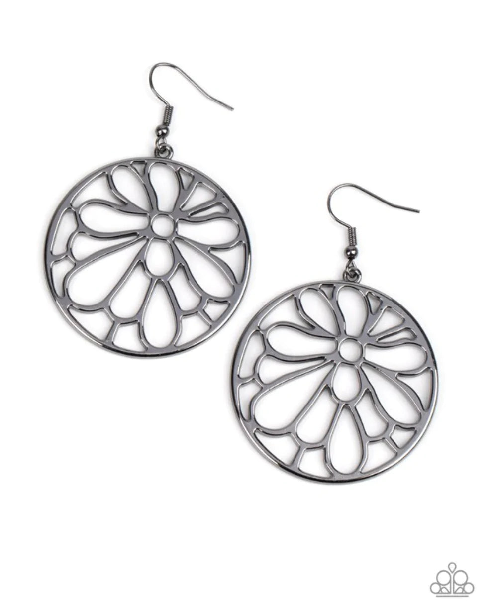 Paparazzi Accessories Glowing Glades - Black A stenciled gunmetal blossom asymmetrically blooms inside a gunmetal hoop, resulting in a whimsical floral fashion. Earring attaches to a standard fishhook fitting. Sold as one pair of earrings. Earrings