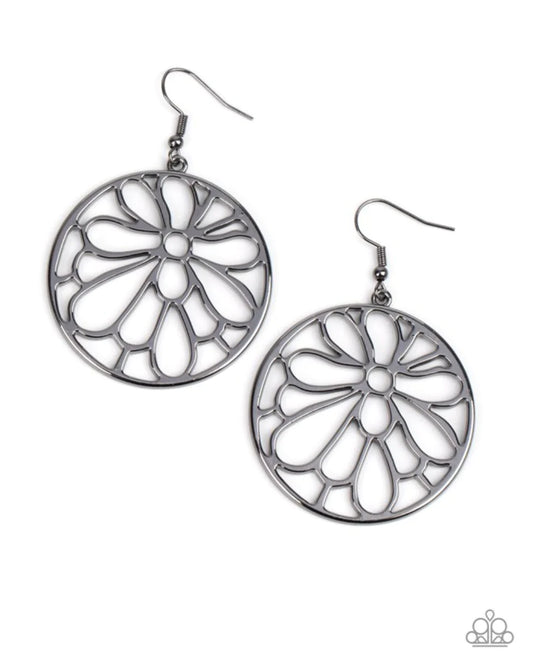 Paparazzi Accessories Glowing Glades - Black A stenciled gunmetal blossom asymmetrically blooms inside a gunmetal hoop, resulting in a whimsical floral fashion. Earring attaches to a standard fishhook fitting. Sold as one pair of earrings. Earrings
