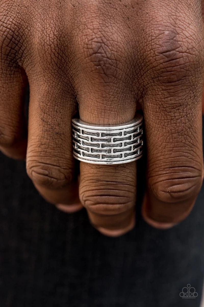 Paparazzi Accessories Tactical Gear - Silver Brushed in an antiqued finish, abstract bar-like patterns are stamped across the front of a thick silver band for a casual look. Features a stretchy band for a flexible fit. Sold as one individual ring. Jewelry