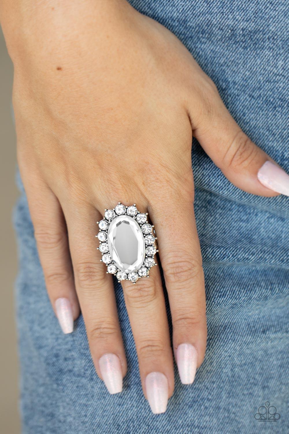 Paparazzi Accessories Bling of All Bling - White White rhinestone encrusted petals bloom from an oversized white gem, creating a dramatic centerpiece atop the finger. Features a stretchy band for a flexible fit. Rings