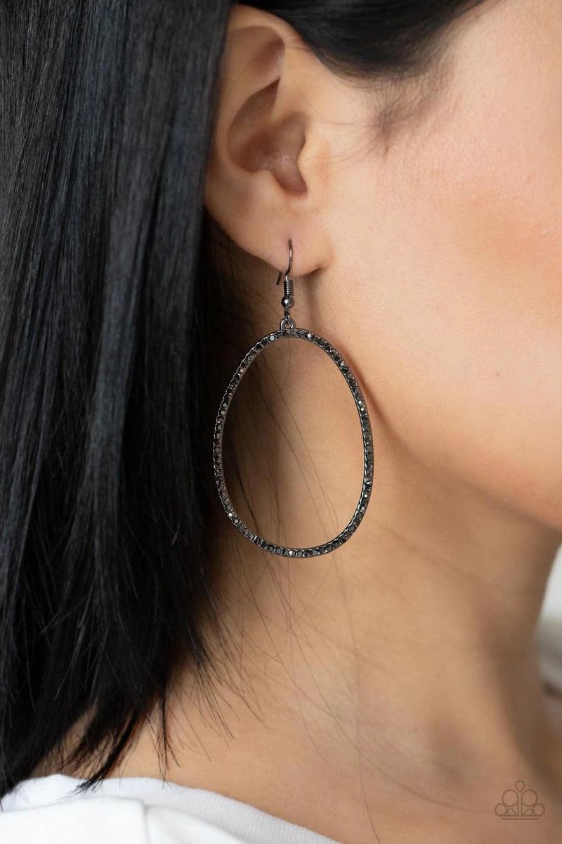 Paparazzi Accessories OVAL-ruled! - Black Dotted in dainty hematite rhinestones, an asymmetrical oval gunmetal frame swings from the ear for a sassy look. Earring attaches to a standard fishhook fitting. Sold as one pair of earrings. Jewelry