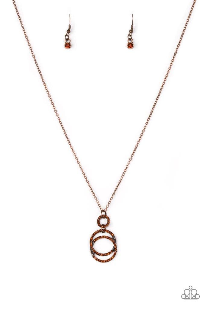 Paparazzi Accessories Timeless Trio - Brass Encrusted in radiant rhinestones, three copper hoops interlock at the bottom of an elongated copper chain for an elegant look. Features an adjustable clasp closure. Sold as one individual necklace. Includes one