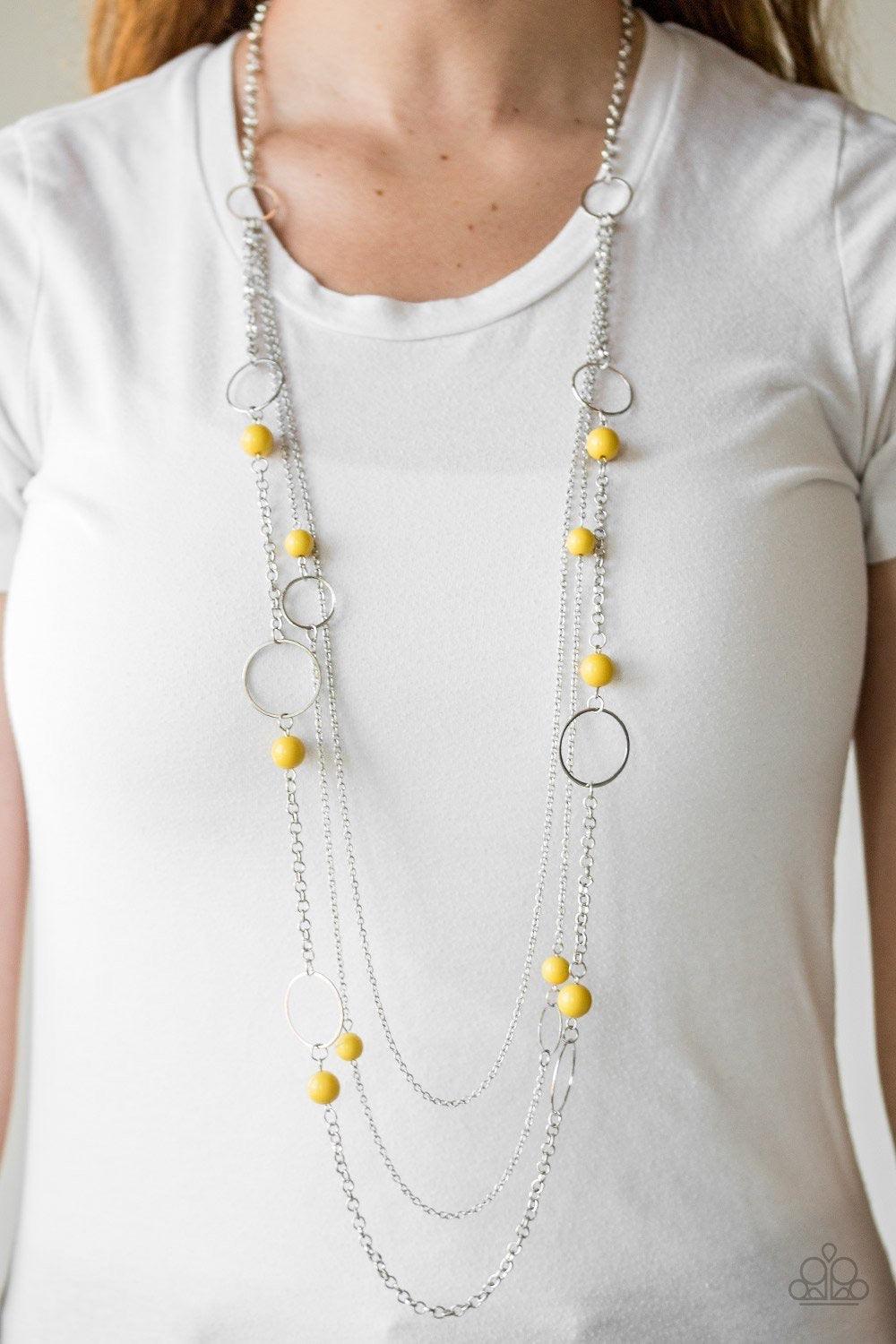 Paparazzi Accessories Beachside Babe - Yellow Featuring hearty yellow beads and shimmery silver hoops, mismatched silver chains layer down the chest for a seasonal look. Features an adjustable clasp closure. Jewelry