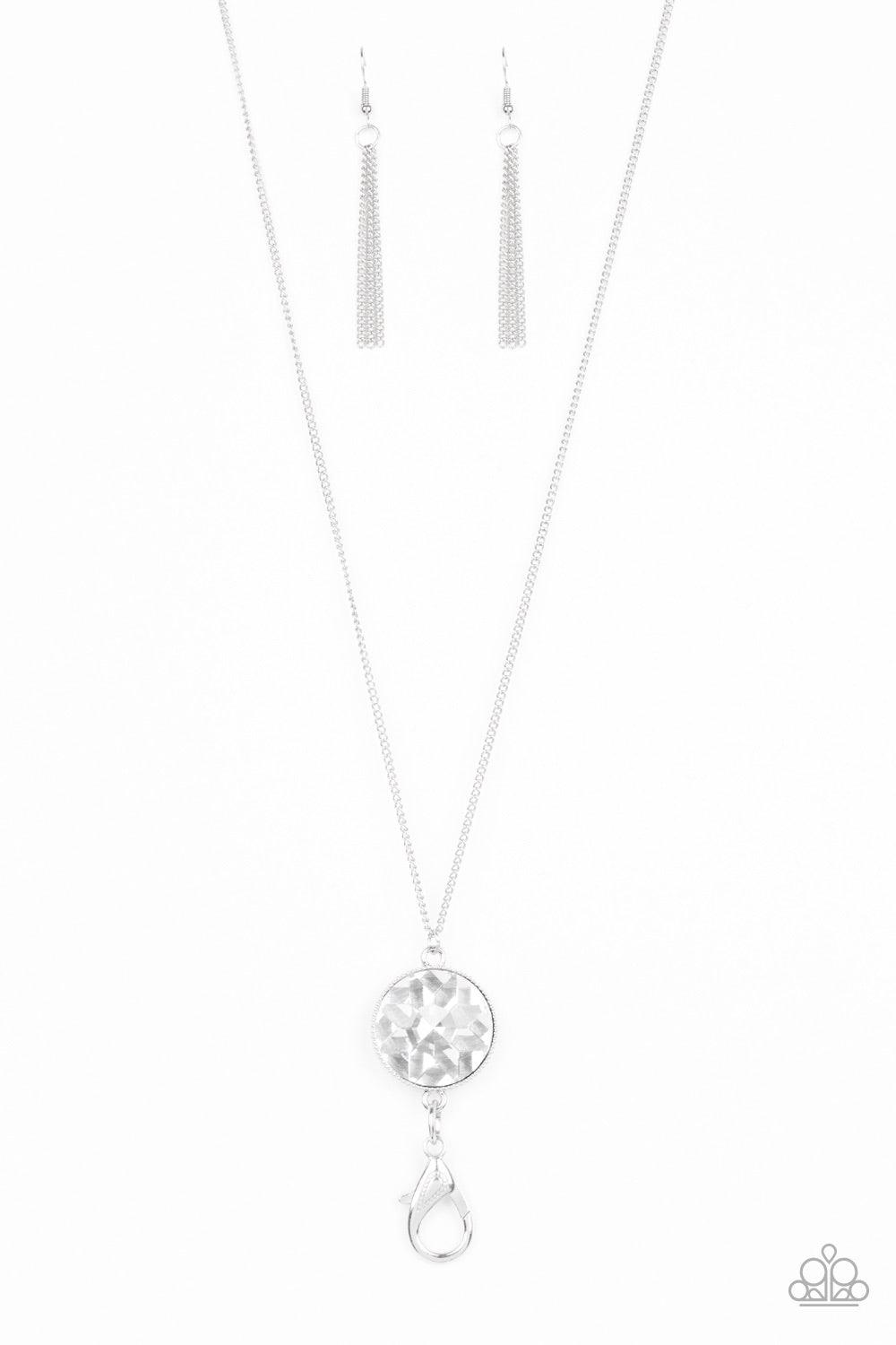 Paparazzi Accessories Dauntless Diva - White An oversized white gem swings from the bottom of a lengthened silver chain for a dramatic look. A lobster clasp hangs from the bottom of the design to allow a name badge or other item to be attached. Features a