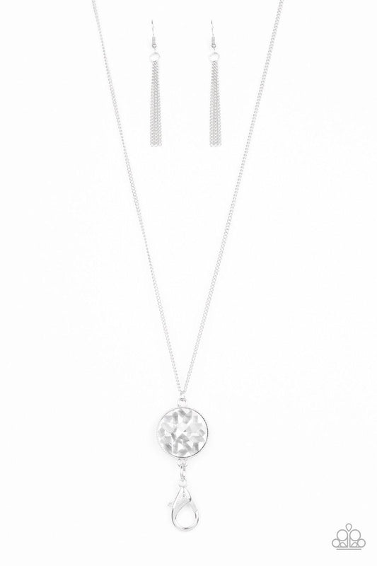 Paparazzi Accessories Dauntless Diva - White An oversized white gem swings from the bottom of a lengthened silver chain for a dramatic look. A lobster clasp hangs from the bottom of the design to allow a name badge or other item to be attached. Features a