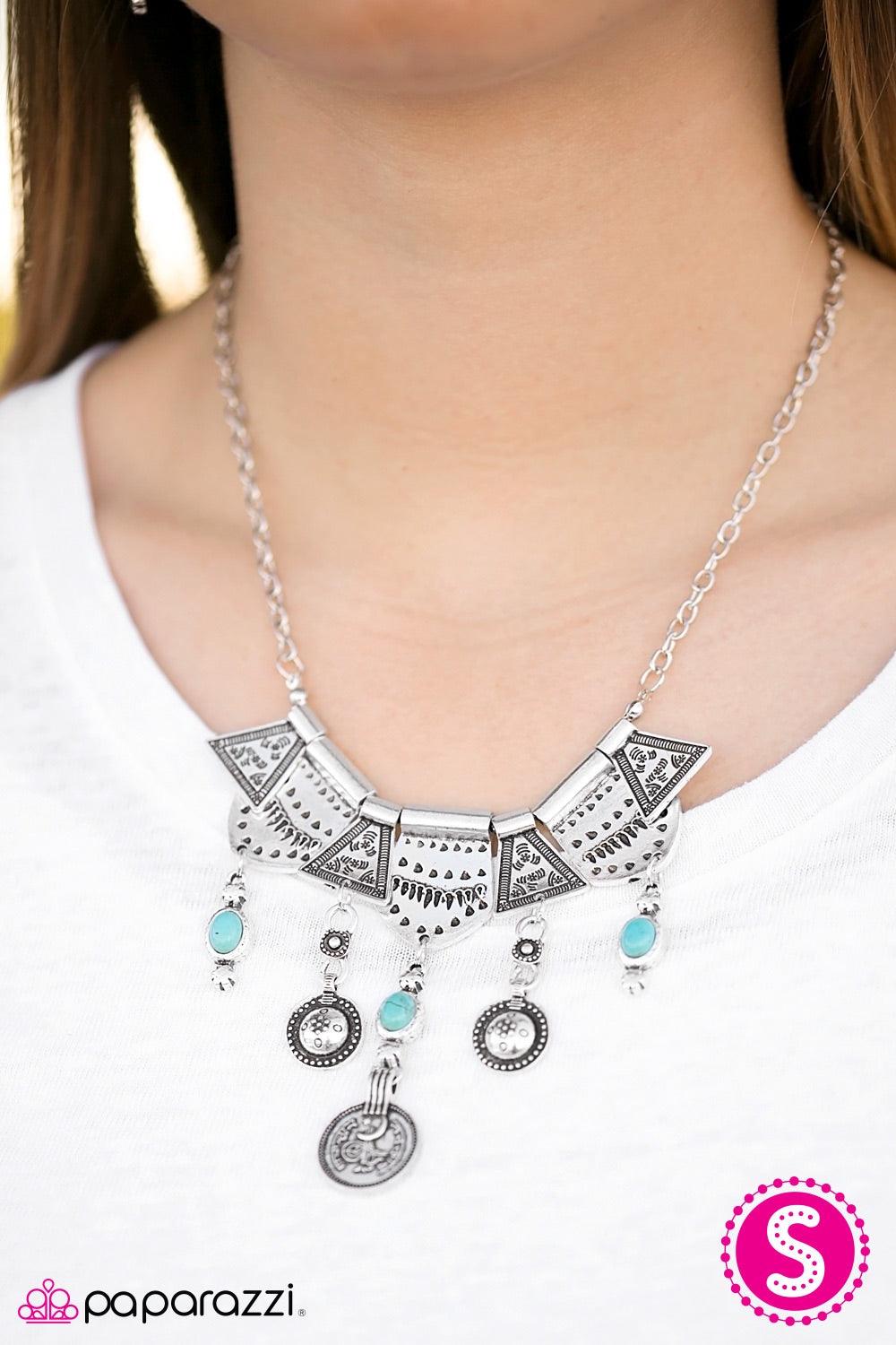 Paparazzi Accessories Paradise Princess - Blue Delicately hammered and etched with tribal patterns, shiny silver plates fan out below the collar in an indigenous fashion. Brushed in an antiqued shimmer, turquoise stone accents swing from the bottom of the