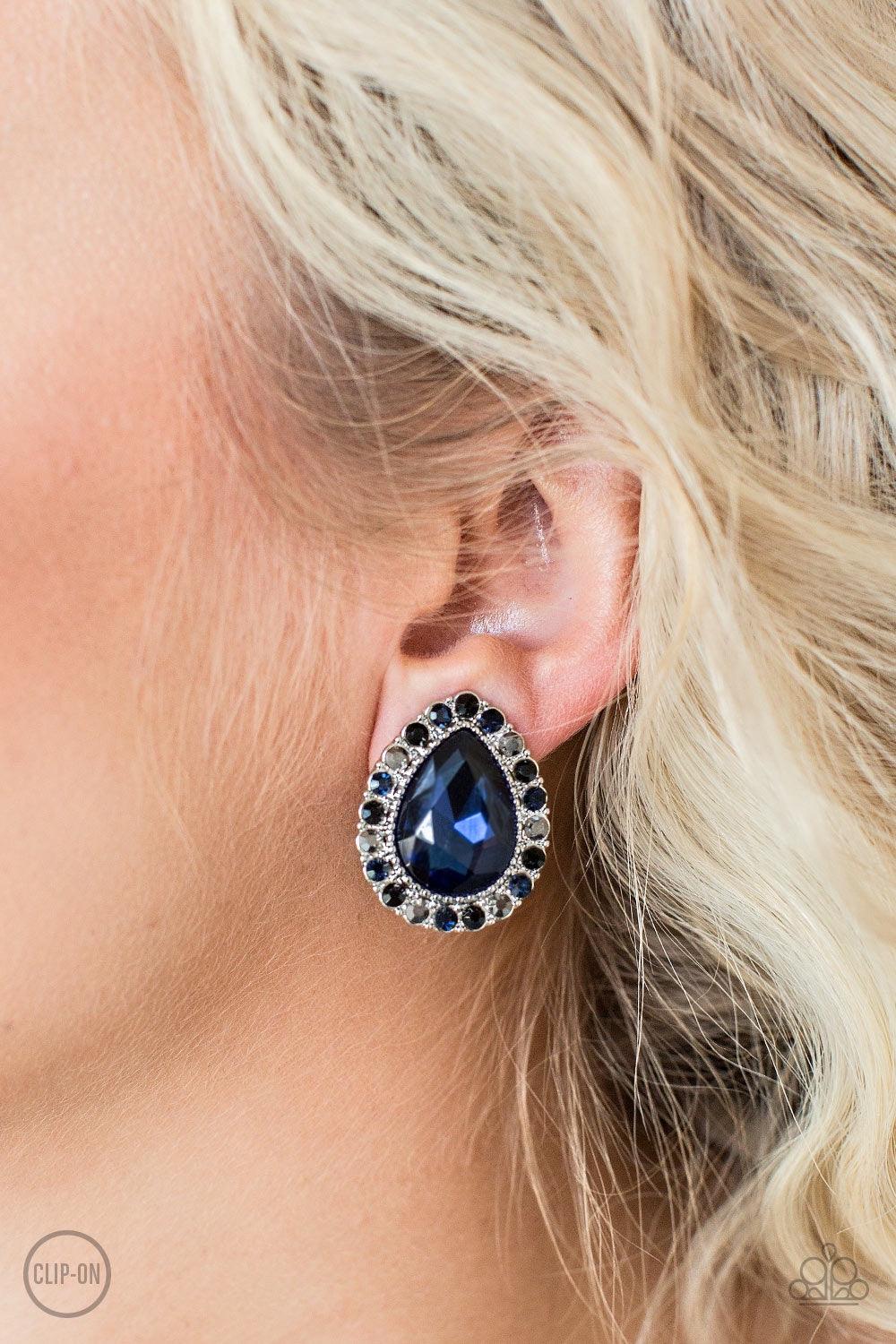 Paparazzi Accessories All HAUTE and Bothered - Multi *Clip-On Glassy black, blue, and hematite rhinestones spin around a faceted blue teardrop gem for a regal look. Earring attaches to a standard clip-on fitting Jewelry