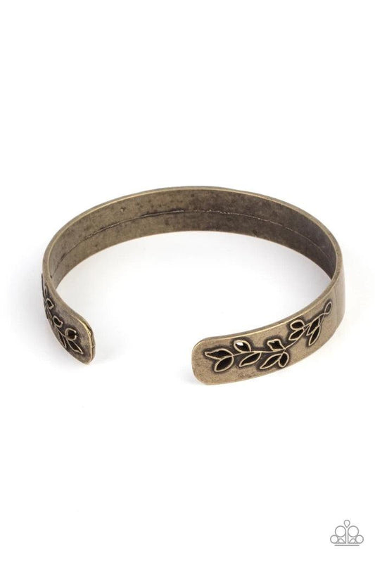 Paparazzi Accessories Frond Fable - Brass The ends of a dainty brass cuff is cutout and embossed in rustic leafy filigree, creating a simple seasonal centerpiece around the wrist. Sold as one individual bracelet. Jewelry