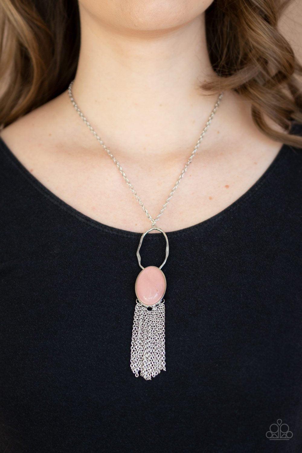 Paparazzi Accessories Dewy Desert - Pink Nestled in a sleek silver frame, a dewy pink stone swings from the bottom of a hammered silver hoop at the bottom of a shiny silver chain. Dainty silver chains stream from the bottom of the tranquil stone pendant,