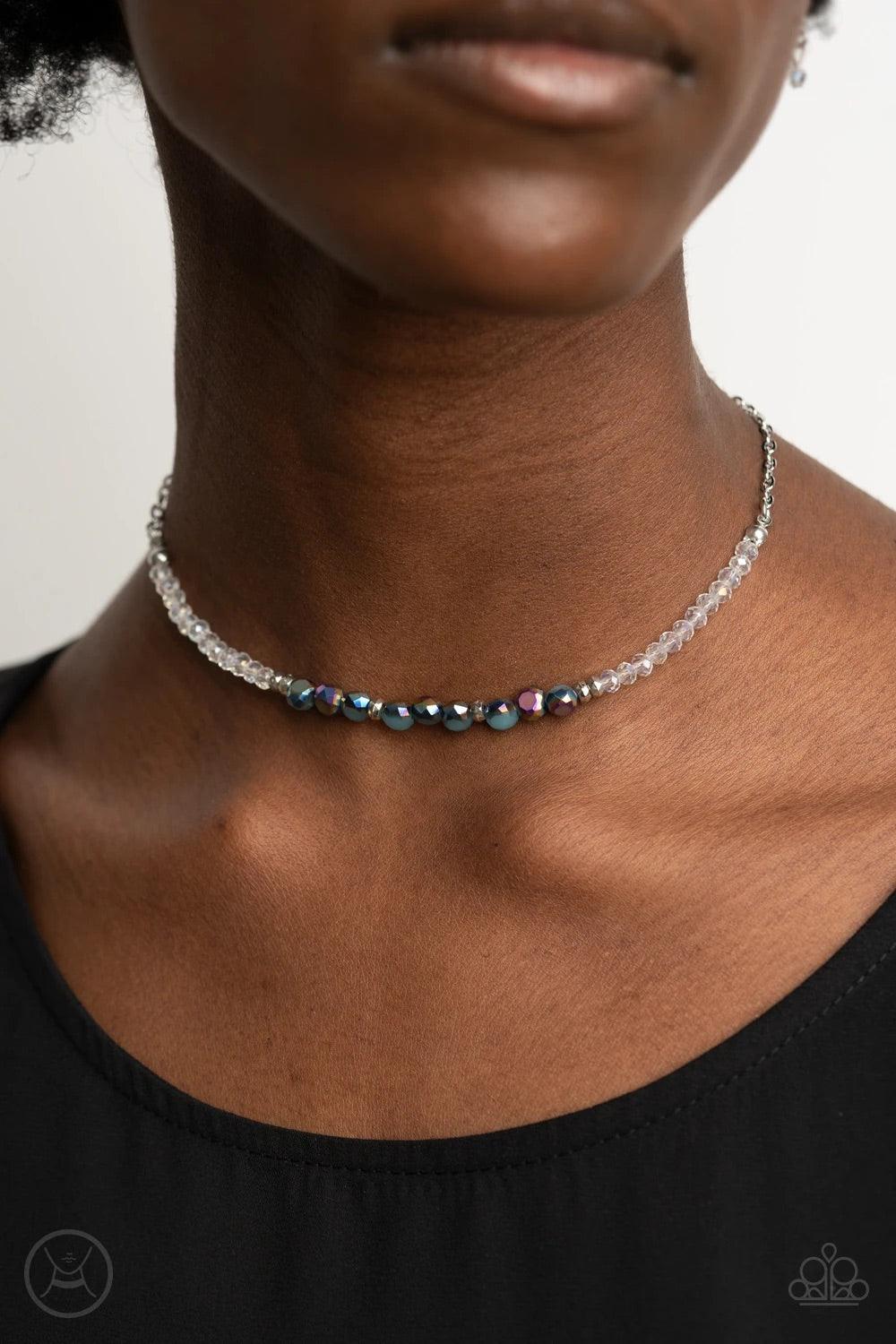 Paparazzi Accessories Space Odyssey ~Multi A dainty collection of mismatched oil spill beads ad iridescent crystal-like accents are threaded along an invisible wire around the neck for a stellar look. Features an adjustable clasp closure. Sold as one indi