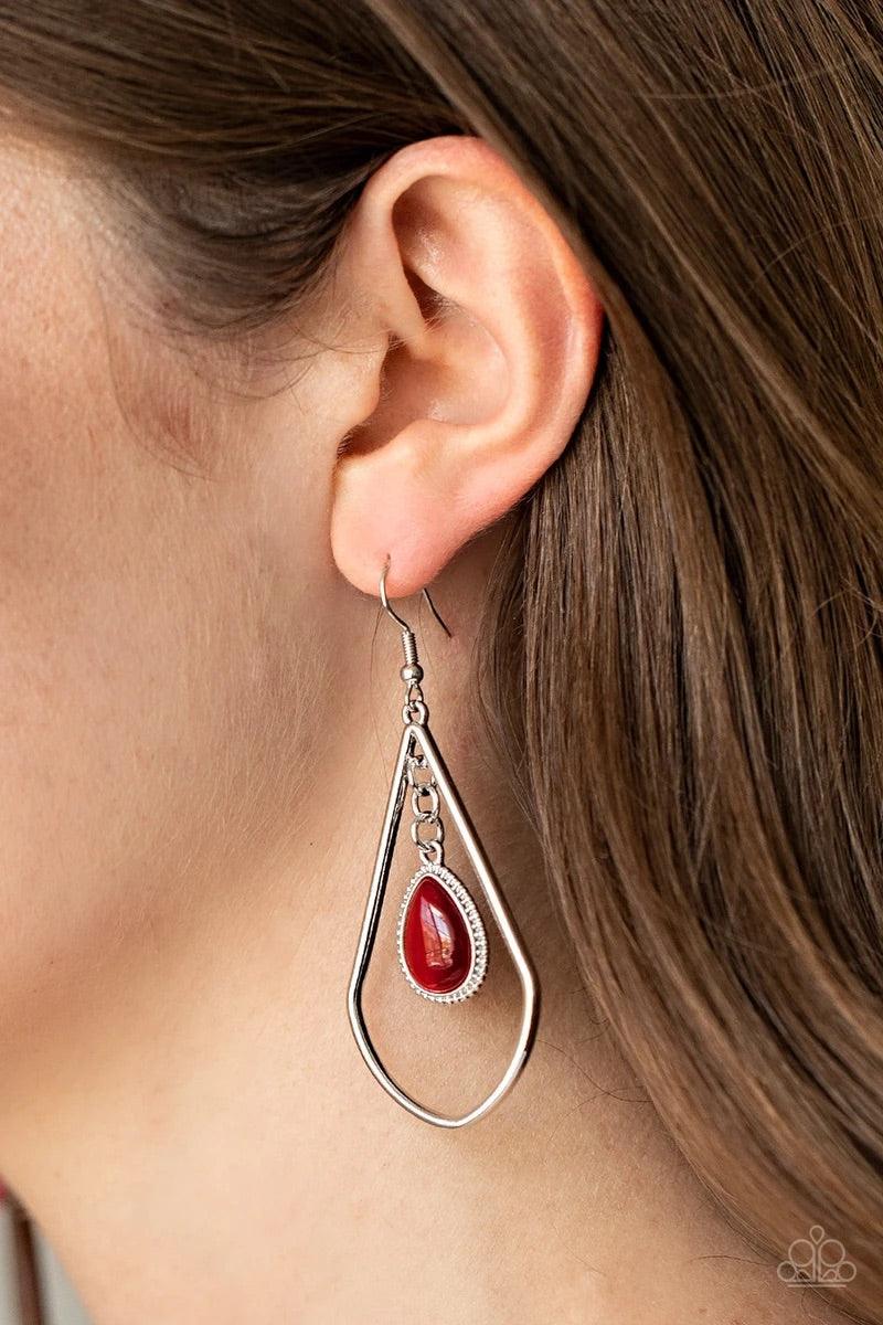 Paparazzi Accessories Ethereal Elegance- Red A dewy red cat's eye stone teardrop frame swings from the top of an angular silver teardrop, creating a whimsical lure. Earring attaches to a standard fishhook fitting. Sold as one pair of earrings. Jewelry