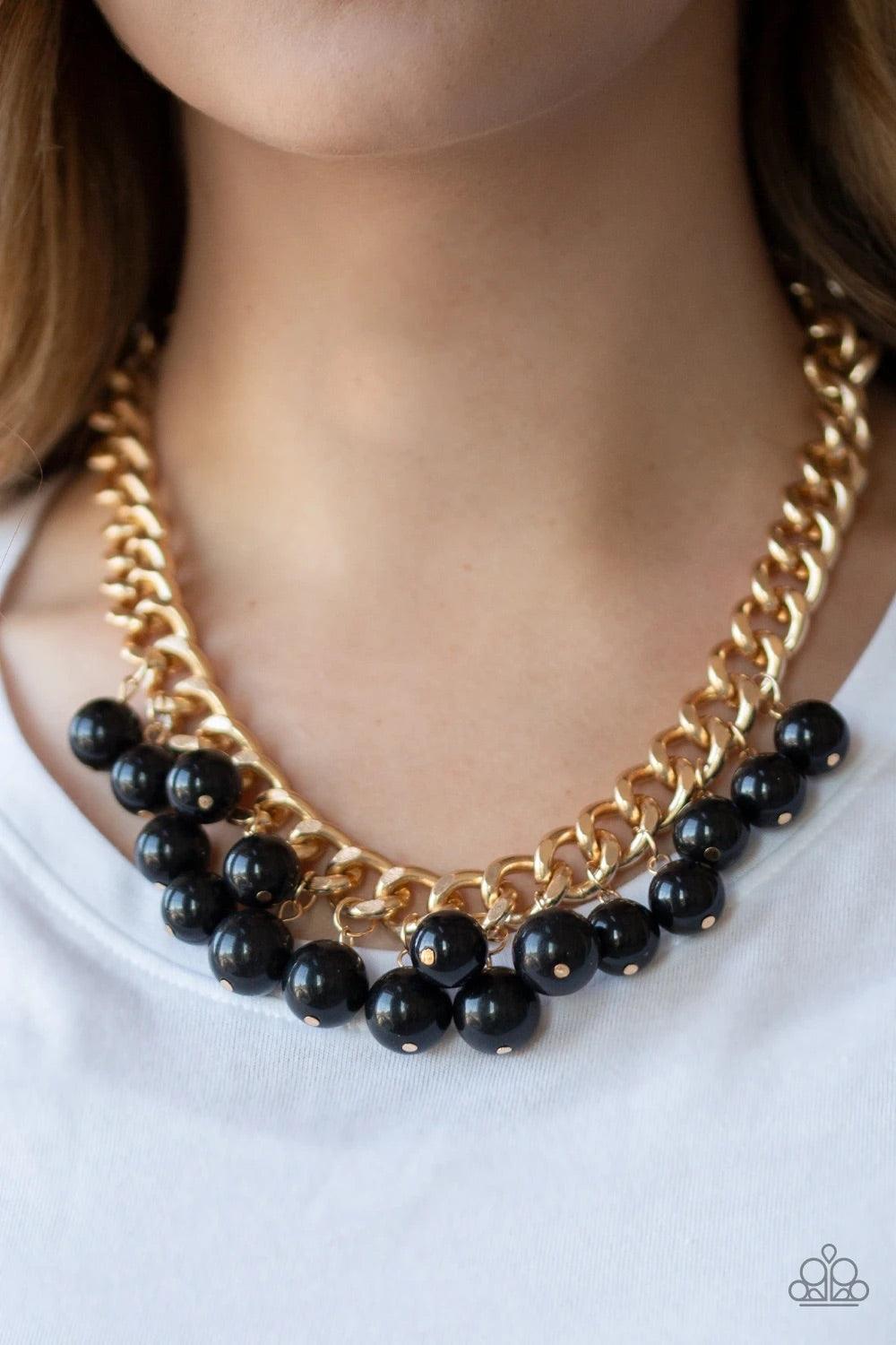 Paparazzi Accessories Get Off My Runway - Gold Bubbly black beads swing from the bottom of a hefty gold chain, creating a dramatic fringe below the collar. Features an adjustable clasp closure. Sold as one individual necklace. Includes one pair of matchin