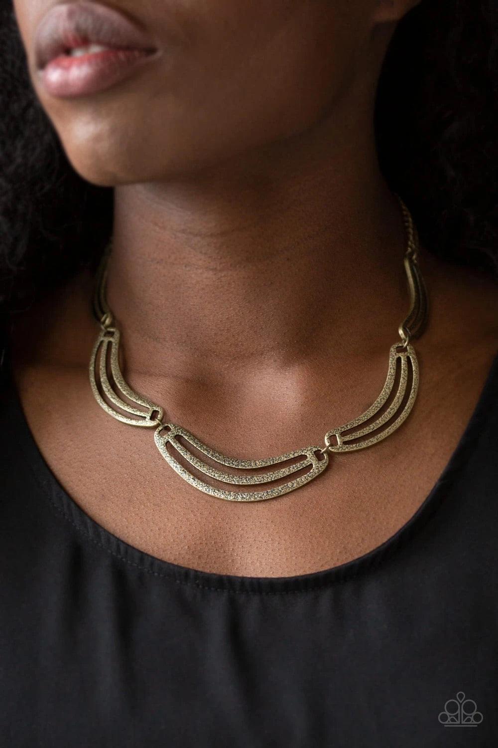 Paparazzi Accessories Palm Springs Pharaoh - Brass Hammered in an antiqued shimmer, airy half-moon shaped brass frames link below the collar in a bold, statement-making fashion. Features an adjustable clasp closure. Jewelry