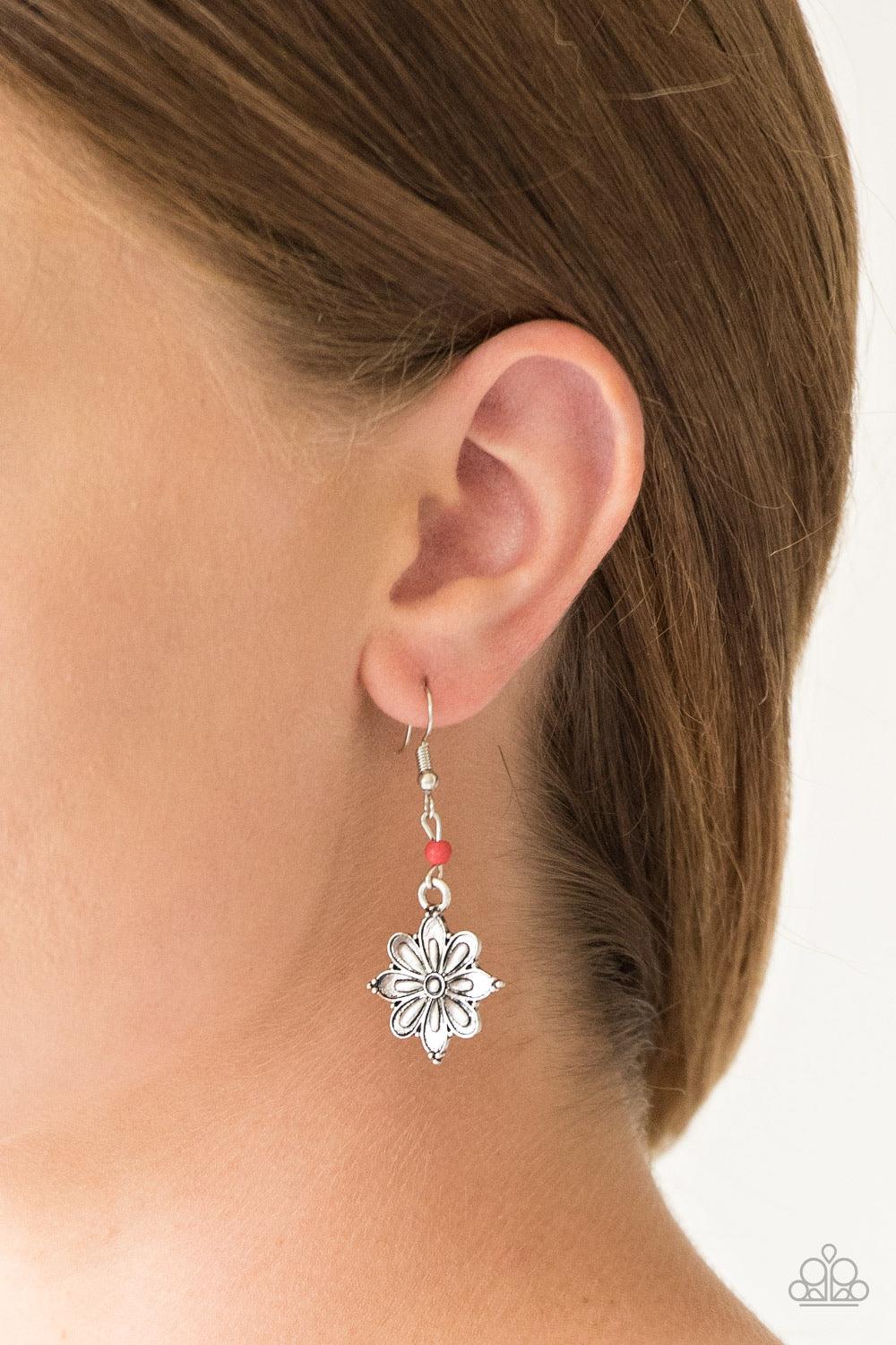 Paparazzi Accessories Cactus Blossom - Red Brushed in a high-sheen finish, a glistening silver flower frame swings from the bottom of a dainty red stone for a seasonal look. Earring attaches to a standard fishhook fitting. Sold as one pair of earrings. Je
