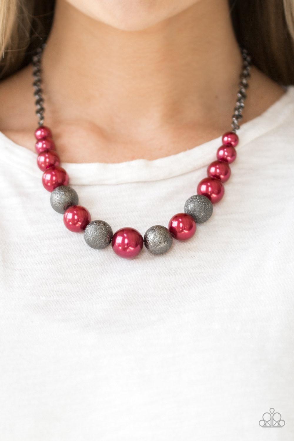 Paparazzi Accessories Color Me CEO - Red Dusted in glitter, sparkling gunmetal and pearly red beads are threaded along an invisible wire below the collar for a glamorous look. Features an adjustable clasp closure. Jewelry