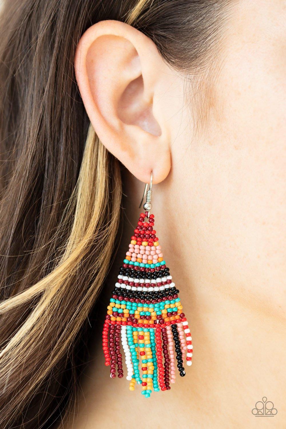 Paparazzi Accessories Beaded Bohemian - Red A dainty collection of red, pink, yellow, black, white, blue, and orange seed beads cascade from the ear in a vivaciously beaded fringe. Earring attaches to a standard fishhook fitting. Sold as one pair of earri