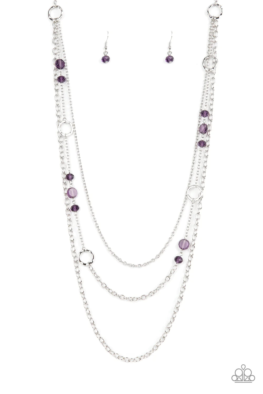 Paparazzi Accessories Starry-Eyed Eloquence - Purple Three mismatched silver chains elegantly drape across the chest. The centermost chain is adorned in textured silver hoops, purple crystal-like beads, and glassy purple gem accents for a sparkly finish.