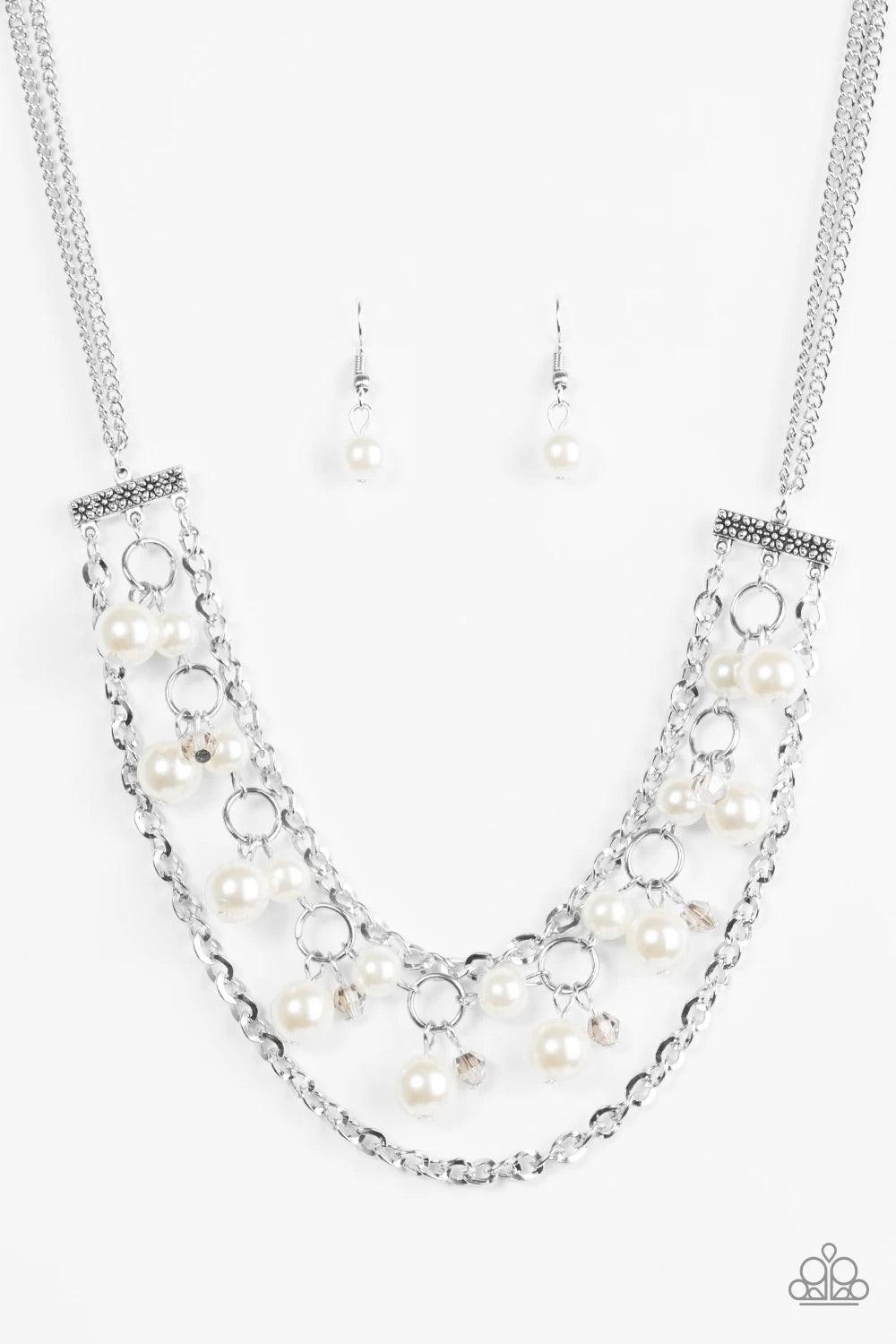 Paparazzi Accessories Rockefeller Romance ~White Attached to two floral fittings, rows of shimmery silver chains flank a pearly beaded strand below the collar. Dramatic white pearls and faceted crystal-like beads swing from the centermost strand for a ref