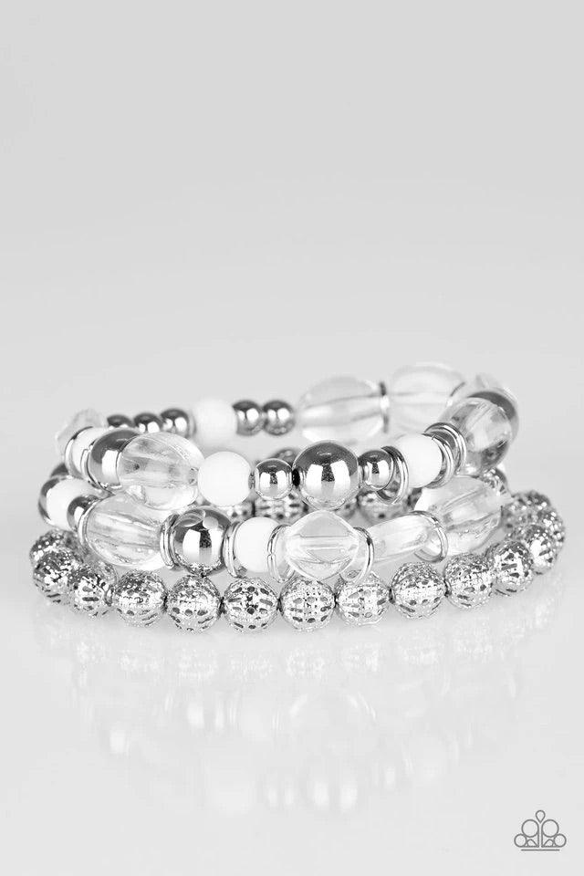Paparazzi Accessories Malibu Marina - White An array of glassy and polished white beading and mismatched silver accents are threaded along stretchy elastic bands, creating colorful layers across the wrist. Sold as one set of three bracelets. Jewelry