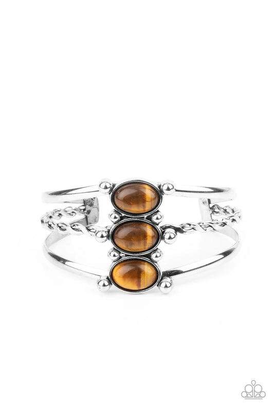 Paparazzi Accessories Extra Earthy - Brown Featuring silver studded fittings, an earthy trio of oval tiger's eye stones adorn the center of an ornately layered silver cuff for a seasonal finish. Sold as one individual bracelet. Jewelry