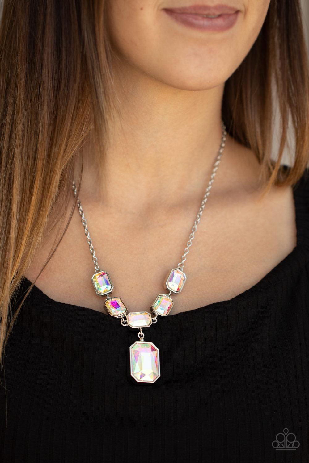 Paparazzi Accessories Million Dollar Moment - Multi Featuring an out-of-this-world iridescence, emerald-cut iridescent gems delicately link below the collar. Attached to a dainty silver chain, the glittering row of rhinestones gives way to a dramatically
