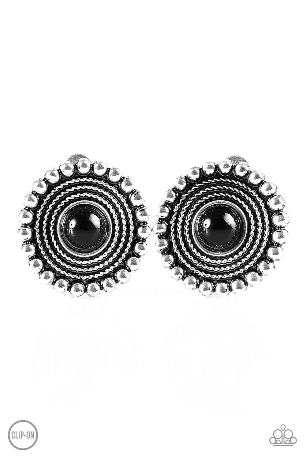 Paparazzi Accessories WHEELing And Able - Black *Clip-On A shiny black bead is pressed into the center of a silver studded frame radiating with shimmery texture for a tribal inspired look. Earring attaches to a standard clip-on fitting. Jewelry